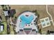 Aerial view of pool with lounge chairs, playground and tennis court in a Gathering community at 11426 Sage Canyon Dr, Riverview, FL 33578