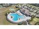Beautiful aerial view of a community pool, tennis courts, with a covered lounge area at 11426 Sage Canyon Dr, Riverview, FL 33578