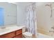 Bright bathroom features a shower-tub combo, white tile and vanity with a neutral color scheme at 1105 Venetian Harbor Ne Dr, St Petersburg, FL 33702