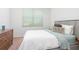 Neutral bedroom with large window letting in natural light and soft natural color accents at 1105 Venetian Harbor Ne Dr, St Petersburg, FL 33702