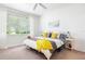 Bright bedroom with a ceiling fan, window, and decorative yellow accents at 1105 Venetian Harbor Ne Dr, St Petersburg, FL 33702
