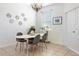 Bright dining room with a modern table set, decorative mirrors, and a sunlit window with neutral decor at 1105 Venetian Harbor Ne Dr, St Petersburg, FL 33702