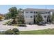 Three-story townhome with multiple balconies, garages, and manicured landscaping creating inviting curb appeal at 1105 Venetian Harbor Ne Dr, St Petersburg, FL 33702