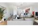 A contemporary living area offering a plush grey sofa, adjacent to the kitchen, and open access to other living spaces at 1105 Venetian Harbor Ne Dr, St Petersburg, FL 33702