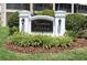 Landscaped Venetian Harbor sign featuring lush greenery and elegant lighting fixtures at 1105 Venetian Harbor Ne Dr, St Petersburg, FL 33702