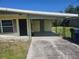 Exterior view of home featuring a large carport and driveway at 125 18Th Nw St, Ruskin, FL 33570