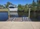 Waterfront property featuring a private dock with access to the canal and lush green vegetation at 125 18Th Nw St, Ruskin, FL 33570