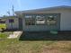 View of home's exterior featuring screened windows and a spacious backyard at 125 18Th Nw St, Ruskin, FL 33570