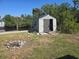 Exterior view of the shed in a well-maintained yard near the lake at 125 18Th Nw St, Ruskin, FL 33570