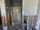 Partially renovated bathroom with exposed studs, plumbing and shower stall in place at 125 18Th Nw St, Ruskin, FL 33570