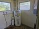 Water heater with white walls and multiple windows at 125 18Th Nw St, Ruskin, FL 33570