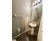 Cozy powder room with pedestal sink, tiled floors, and modern lighting fixtures at 12717 Lemon Pepper Dr, Riverview, FL 33578