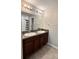 Bright bathroom featuring double sink vanity, granite countertop, with tiled floors and a shower with curtain at 12717 Lemon Pepper Dr, Riverview, FL 33578