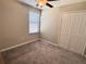 Bedroom with neutral carpet, double door closet, and ceiling fan at 12717 Lemon Pepper Dr, Riverview, FL 33578
