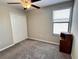 This bedroom features neutral walls, plush gray carpeting, closet, ceiling fan, and a bright window at 12717 Lemon Pepper Dr, Riverview, FL 33578