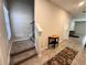 Inviting entryway featuring neutral paint, staircase, and accent table at 12717 Lemon Pepper Dr, Riverview, FL 33578