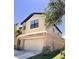 Two-story home with a beige exterior, a two-car garage, well-manicured lawn, and nicely landscaped yard at 12717 Lemon Pepper Dr, Riverview, FL 33578