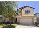 Inviting two-story home featuring a neutral color palette, attached two-car garage, and well-maintained landscaping at 12717 Lemon Pepper Dr, Riverview, FL 33578