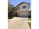 Inviting two-story home with a neutral color palette, attached two-car garage, and manicured landscaping at 12717 Lemon Pepper Dr, Riverview, FL 33578