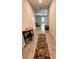 Inviting hallway with a decorative table, runner, and easy access to living areas at 12717 Lemon Pepper Dr, Riverview, FL 33578
