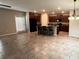 Open-concept kitchen with a center island, black appliances, dark wood cabinets, and access to the backyard at 12717 Lemon Pepper Dr, Riverview, FL 33578