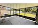 Enclosed screened patio with a concrete floor that overlooks a well-maintained lawn and features black metal framing at 12717 Lemon Pepper Dr, Riverview, FL 33578
