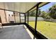 Enclosed screened patio with a concrete floor that overlooks a well-maintained lawn and features black metal framing at 12717 Lemon Pepper Dr, Riverview, FL 33578