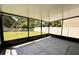 Enclosed screened patio with a concrete floor that overlooks a well-maintained lawn and features black metal framing at 12717 Lemon Pepper Dr, Riverview, FL 33578