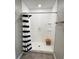 Bright shower area with white tile, glass shelves and a black and white striped shower curtain at 12717 Lemon Pepper Dr, Riverview, FL 33578