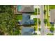 An aerial view displays the property with a well-maintained yard and a long driveway at 12965 Satin Lily Dr, Riverview, FL 33579