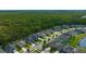 Aerial view of a neighborhood with well-maintained homes, lush green lawns, and mature trees near a greenbelt at 12965 Satin Lily Dr, Riverview, FL 33579