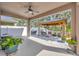 Covered back patio with outdoor seating, ceiling fan, and outdoor grill at 12965 Satin Lily Dr, Riverview, FL 33579