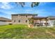 Spacious backyard with a well-maintained lawn and a cozy pergola-covered patio area at 12965 Satin Lily Dr, Riverview, FL 33579