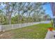 Spacious backyard featuring a white picket fence and mature trees for added privacy at 12965 Satin Lily Dr, Riverview, FL 33579