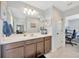 Modern bathroom features a spacious vanity, ample lighting, and a peek into the connecting bedroom at 12965 Satin Lily Dr, Riverview, FL 33579