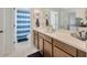 Bright bathroom with a wide countertop vanity, ample storage, and a convenient shower with blue accents at 12965 Satin Lily Dr, Riverview, FL 33579