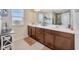 Bathroom featuring double sinks, a large mirror, a tiled floor, and plenty of storage space at 12965 Satin Lily Dr, Riverview, FL 33579