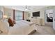 Inviting bedroom featuring a cozy bed, soft neutral tones, and a large window for natural light at 12965 Satin Lily Dr, Riverview, FL 33579