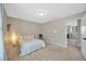 Cozy bedroom with neutral tones, carpet floors, and comfortable queen bed with easy access to the restroom at 12965 Satin Lily Dr, Riverview, FL 33579