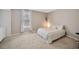 Serene bedroom with a comfortable bed, neutral colors, and soft carpet, perfect for relaxation at 12965 Satin Lily Dr, Riverview, FL 33579