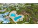 Aerial view of a community pool area featuring multiple pools, a splash pad, and a playground at 12965 Satin Lily Dr, Riverview, FL 33579