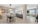 Open-concept dining room adjacent to the living area, featuring tile floors and modern decor at 12965 Satin Lily Dr, Riverview, FL 33579