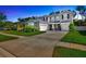 Charming two-story home featuring a well-manicured lawn and a spacious driveway leading to a two-car garage at 12965 Satin Lily Dr, Riverview, FL 33579