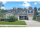 Beautiful two-story home featuring lush green lawn, manicured landscaping and three car garage at 12965 Satin Lily Dr, Riverview, FL 33579
