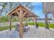 Outdoor entertainment space with covered gazebo, seating, and a view of the fenced backyard at 12965 Satin Lily Dr, Riverview, FL 33579