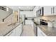 Beautiful kitchen design with stainless steel appliances, granite countertops, and tiled flooring with a view of the stairs at 12965 Satin Lily Dr, Riverview, FL 33579