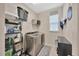 Bright laundry room with front load washer/dryer and shelving at 12965 Satin Lily Dr, Riverview, FL 33579