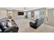 Comfortable upstairs living area with a wood accent wall, media setup, and large windows for natural light at 12965 Satin Lily Dr, Riverview, FL 33579