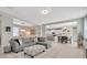 Open concept living room leading to the dining room and kitchen, featuring stylish decor at 12965 Satin Lily Dr, Riverview, FL 33579