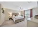 Bright main bedroom with accent wall, ceiling fan, and bedside lamps at 12965 Satin Lily Dr, Riverview, FL 33579